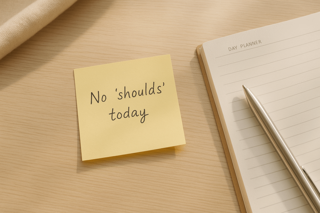 clean day planner flat-lay with a soft-note reminder to skip the “shoulds” and choose what matters