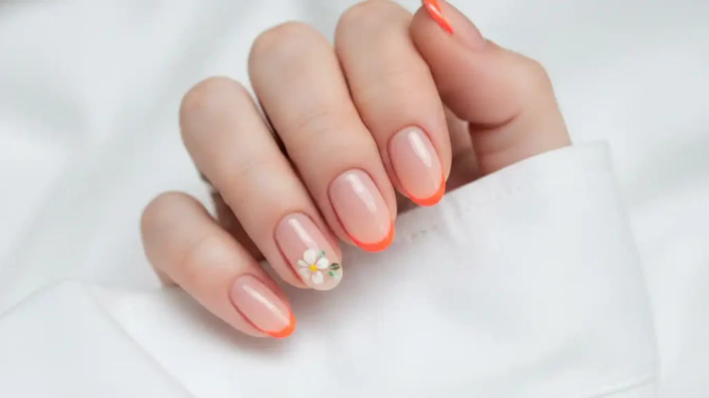 Sheer soap nails with nude base, one neon French tip and one tiny floral accent nail.