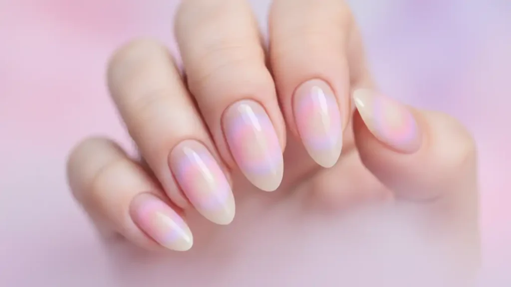 Nails with sheer nude base and soft pink and lavender aura glow in the center of each nail.
